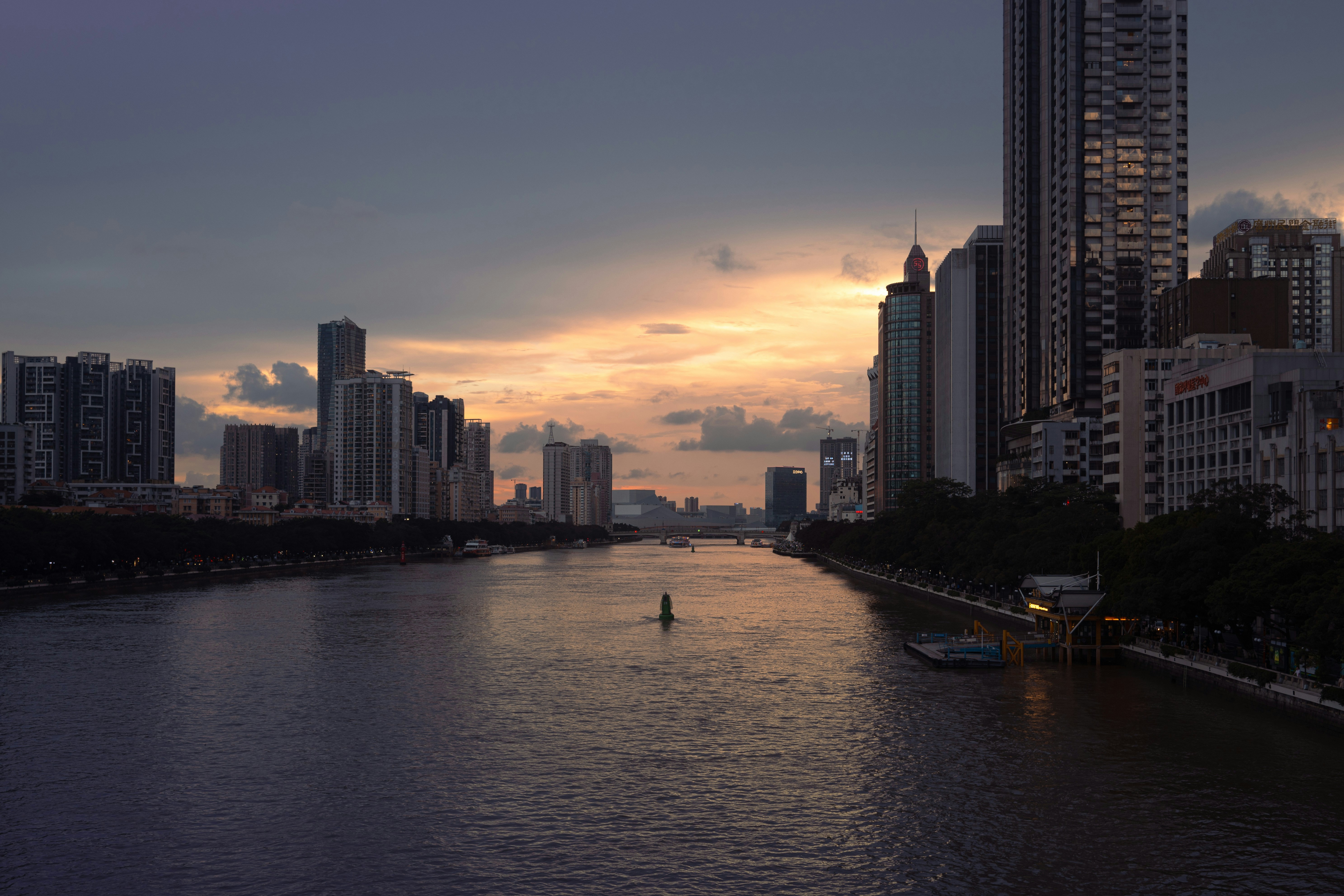 a body of water with buildings in the background