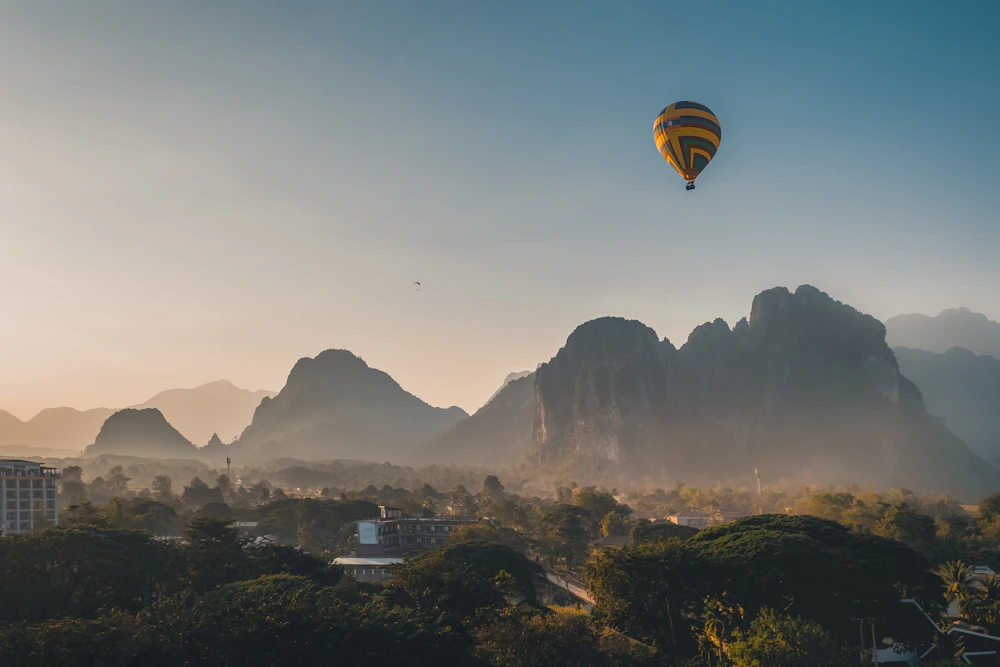Hot air balloon over Vang Vieng karsts at sunset