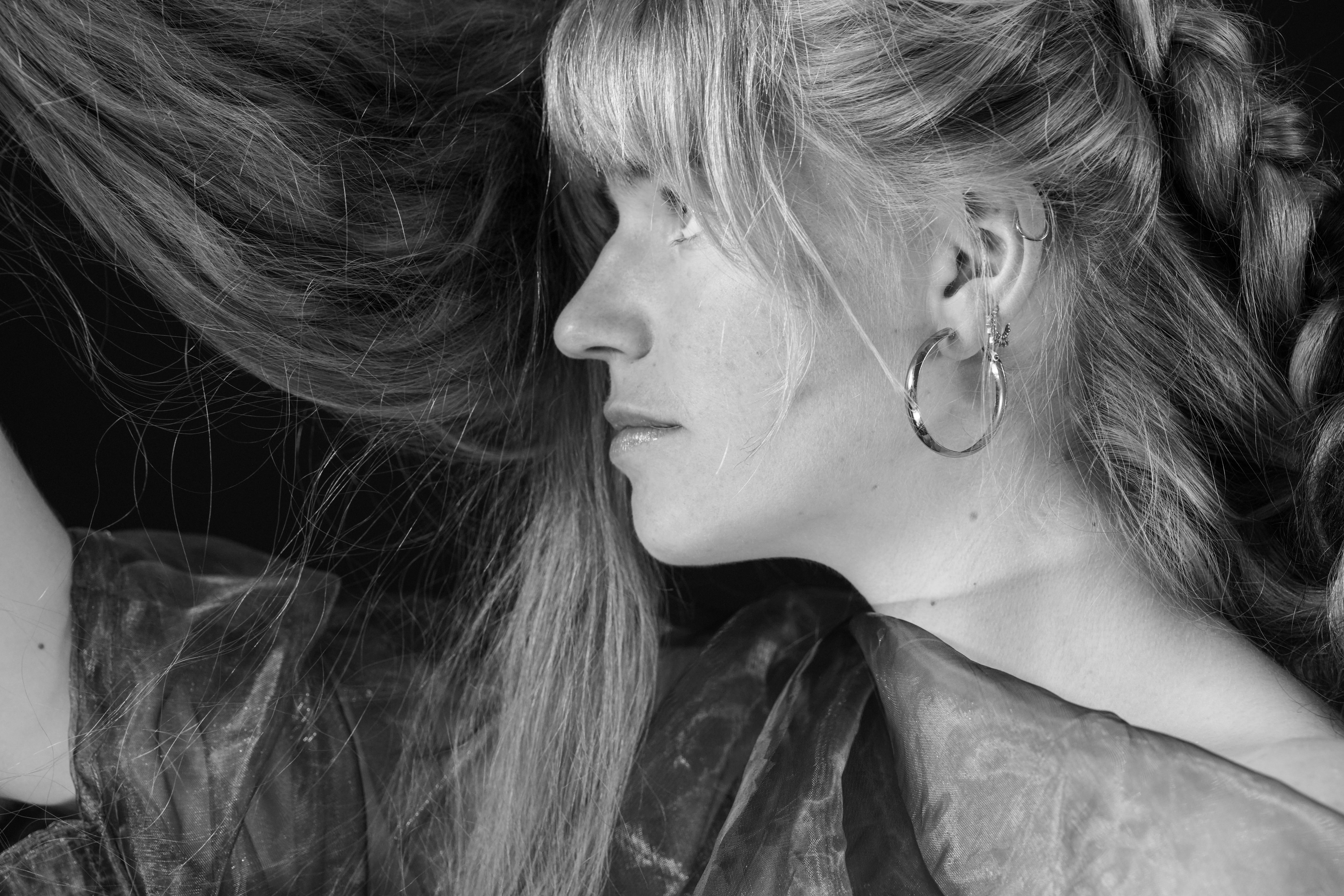 a black and white photo of a woman with long hair