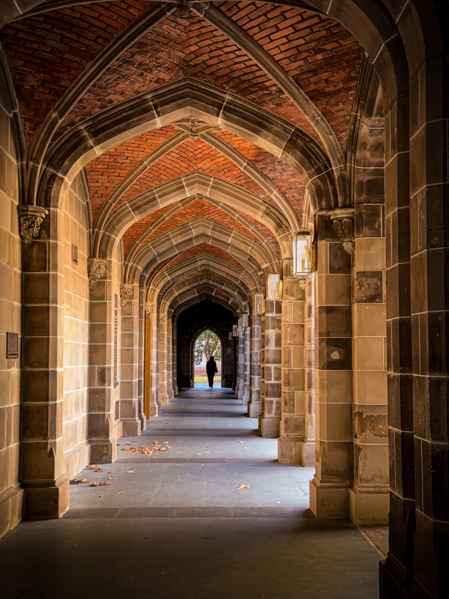 Student walking through a campus archway