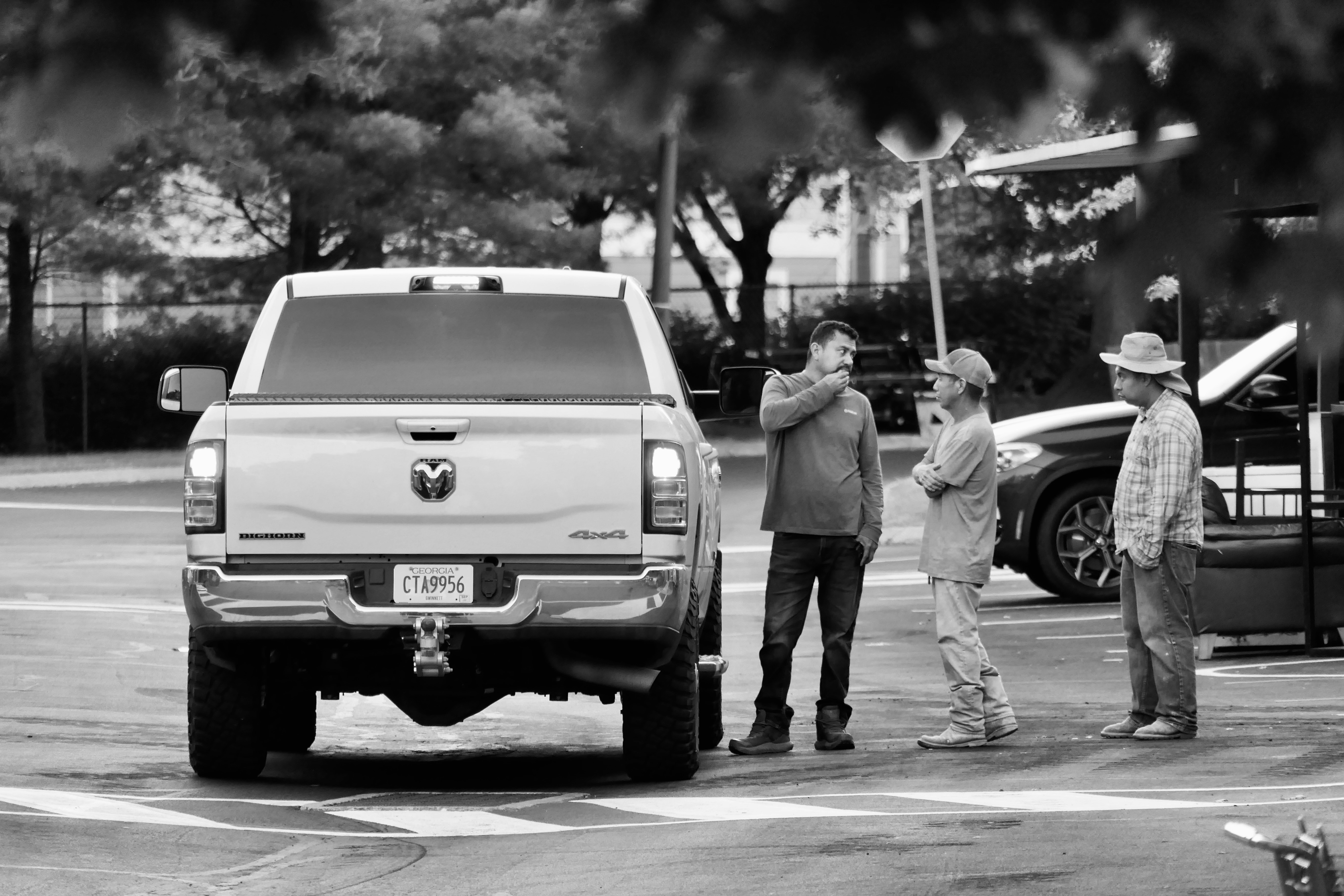 a group of people standing around a white truck