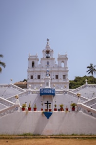 a white church with a cross on the top of it