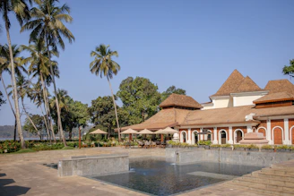 a large building with a pool in front of it
