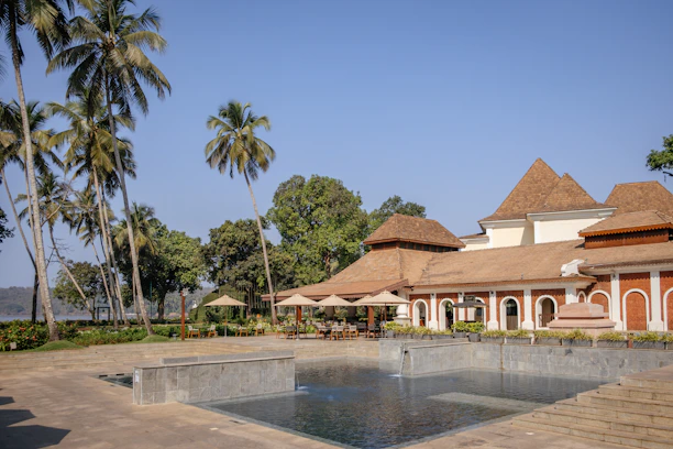 a large building with a pool in front of it