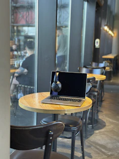 a laptop computer sitting on top of a wooden table