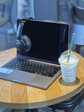 a laptop computer sitting on top of a wooden table