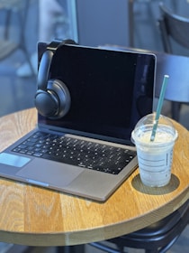 a laptop computer sitting on top of a wooden table