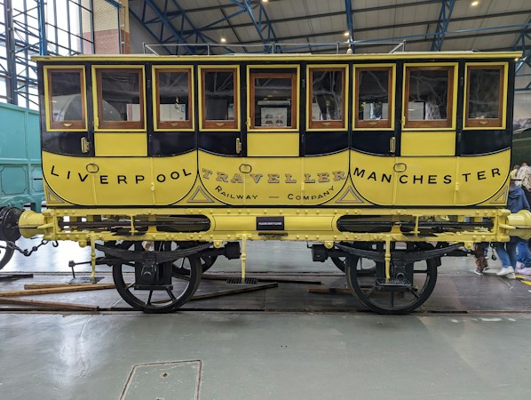Historic train car on display inside a railroad museum building