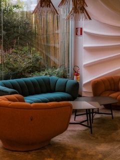 a living room filled with furniture next to a window