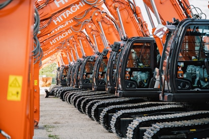 a row of orange machines sitting next to each other