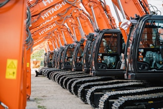 a row of orange machines sitting next to each other