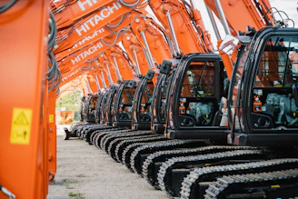 a row of orange machines sitting next to each other