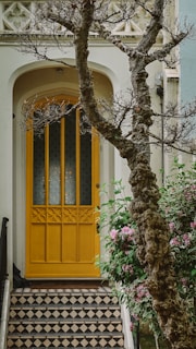 a yellow door with a black and white checkered floor