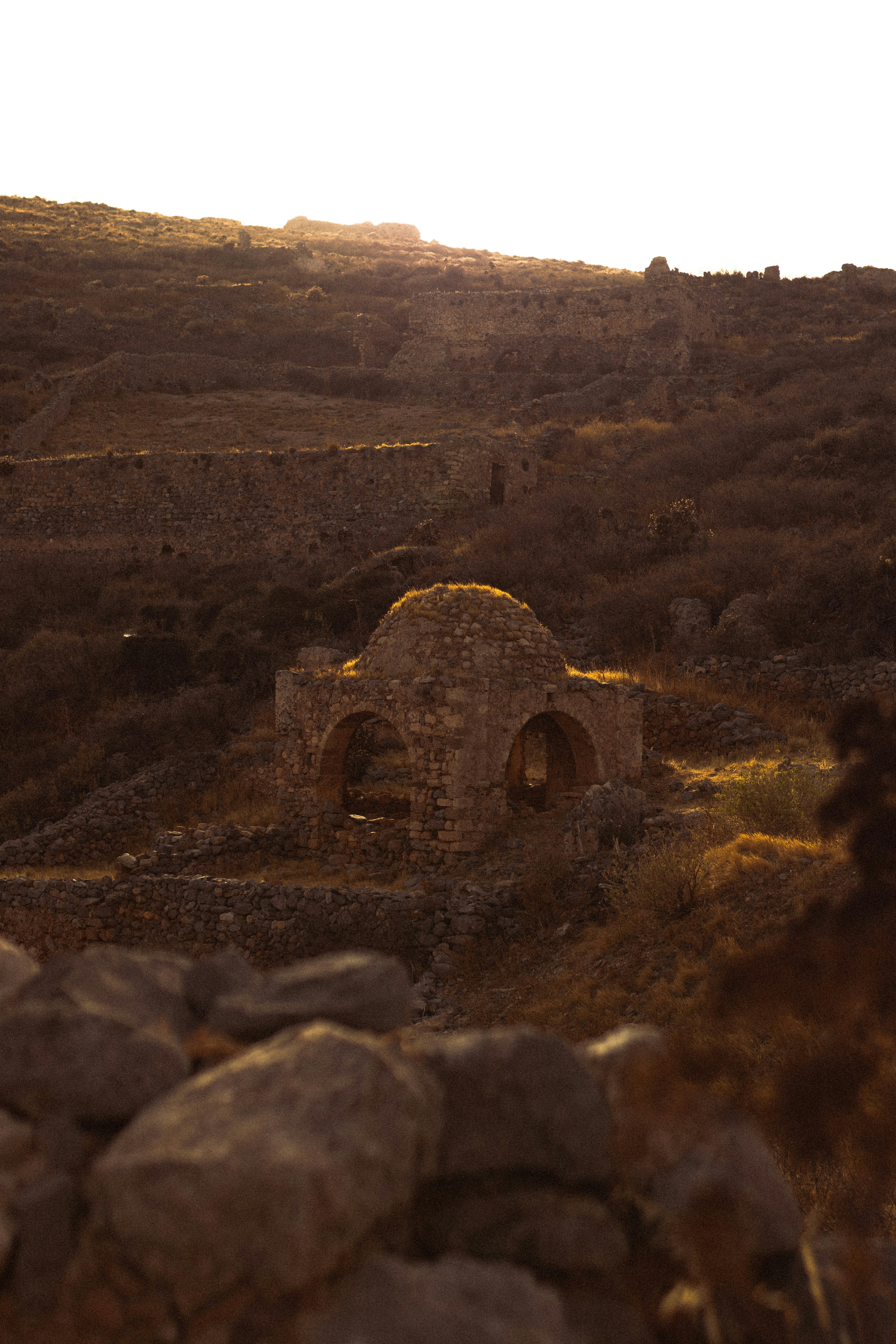 a stone building sitting on top of a rocky hillside