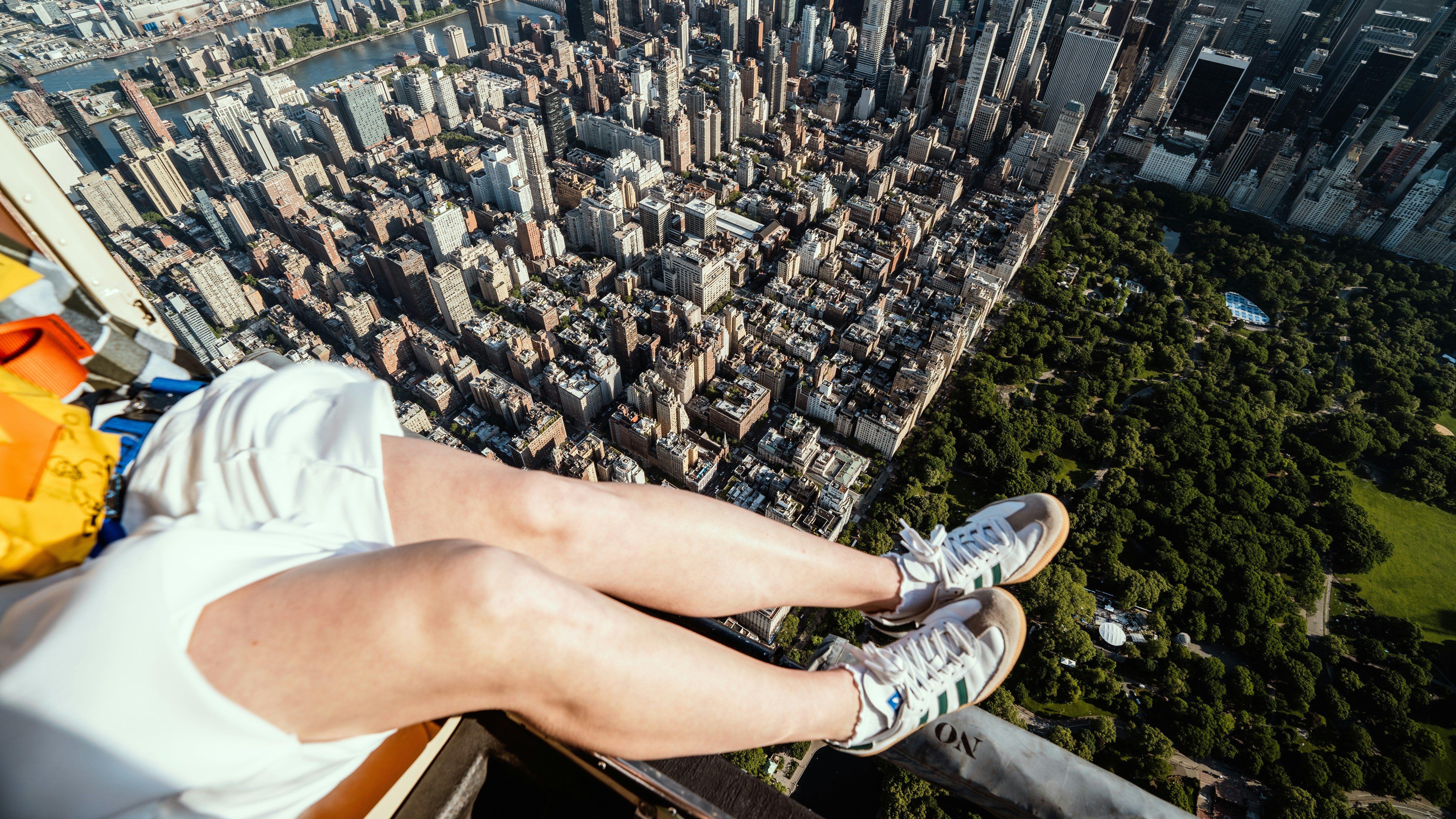 a person sitting on top of a tall building