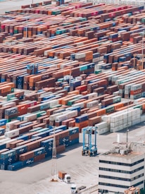 a large amount of cargo containers are stacked together
