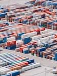 a large group of shipping containers are stacked together