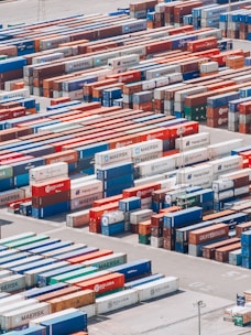 a large group of shipping containers are stacked together