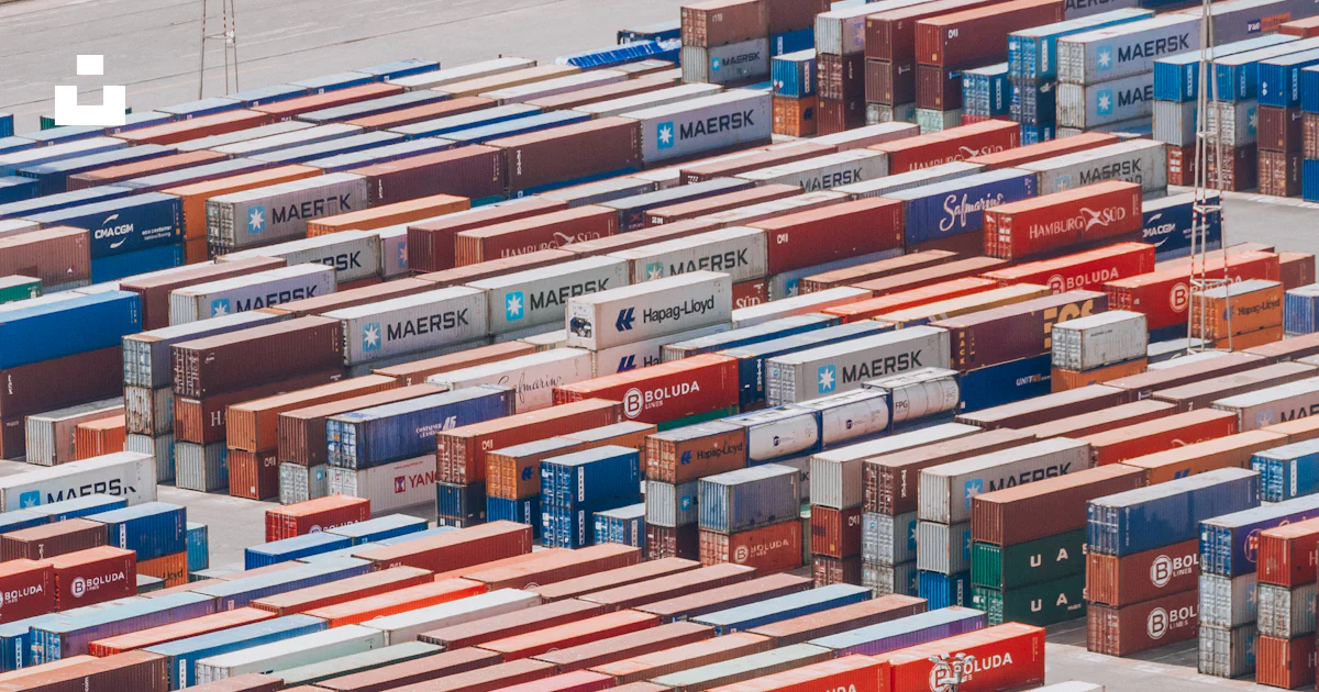 A large group of shipping containers are stacked together photo – Free ...