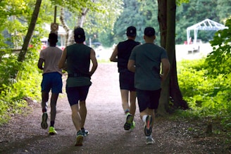 a group of people running down a dirt road
