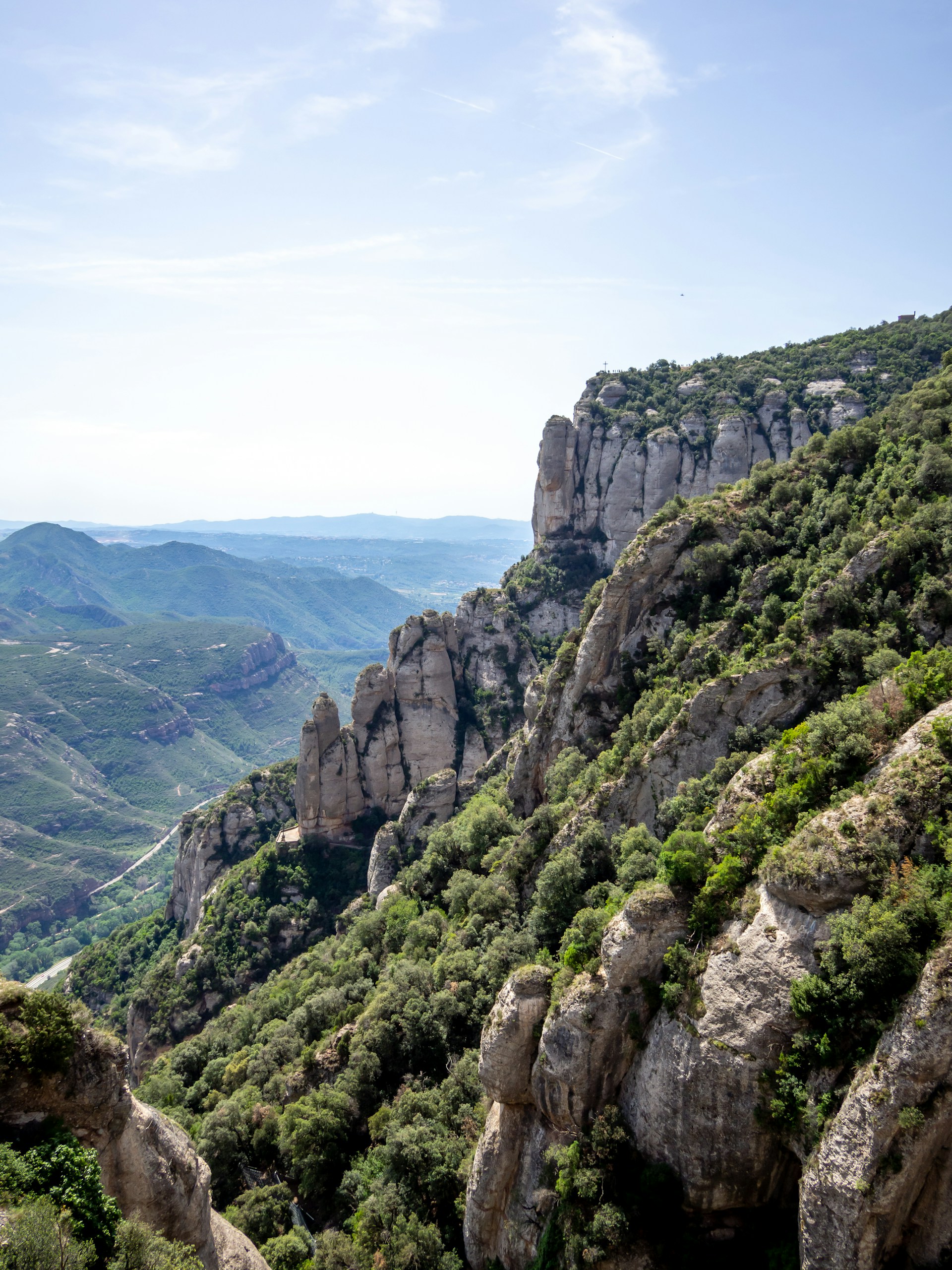 a view of a rocky mountain with a valley below
