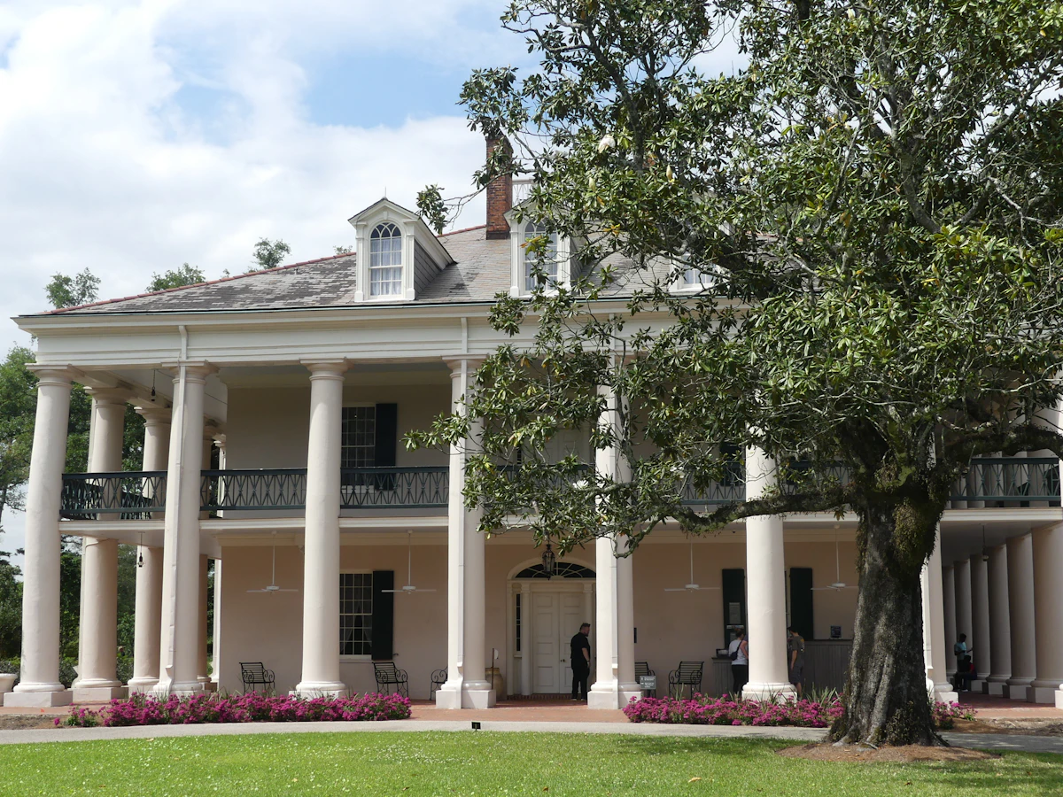 A classic Southern Colonial Revival home with white columns and a magnolia tree in Druid Hills, Atlanta.