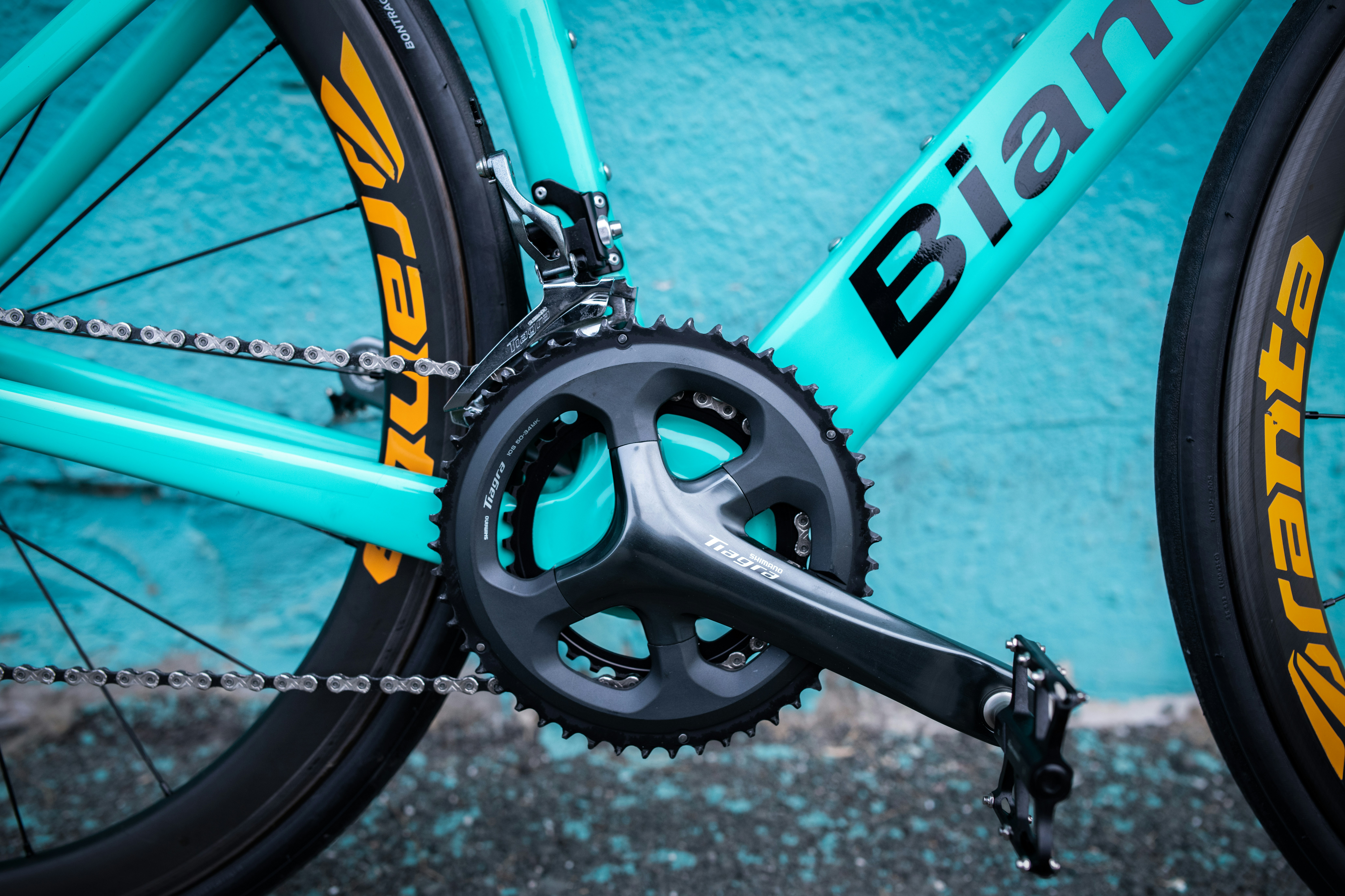 a close up of a bike with a blue wall in the background