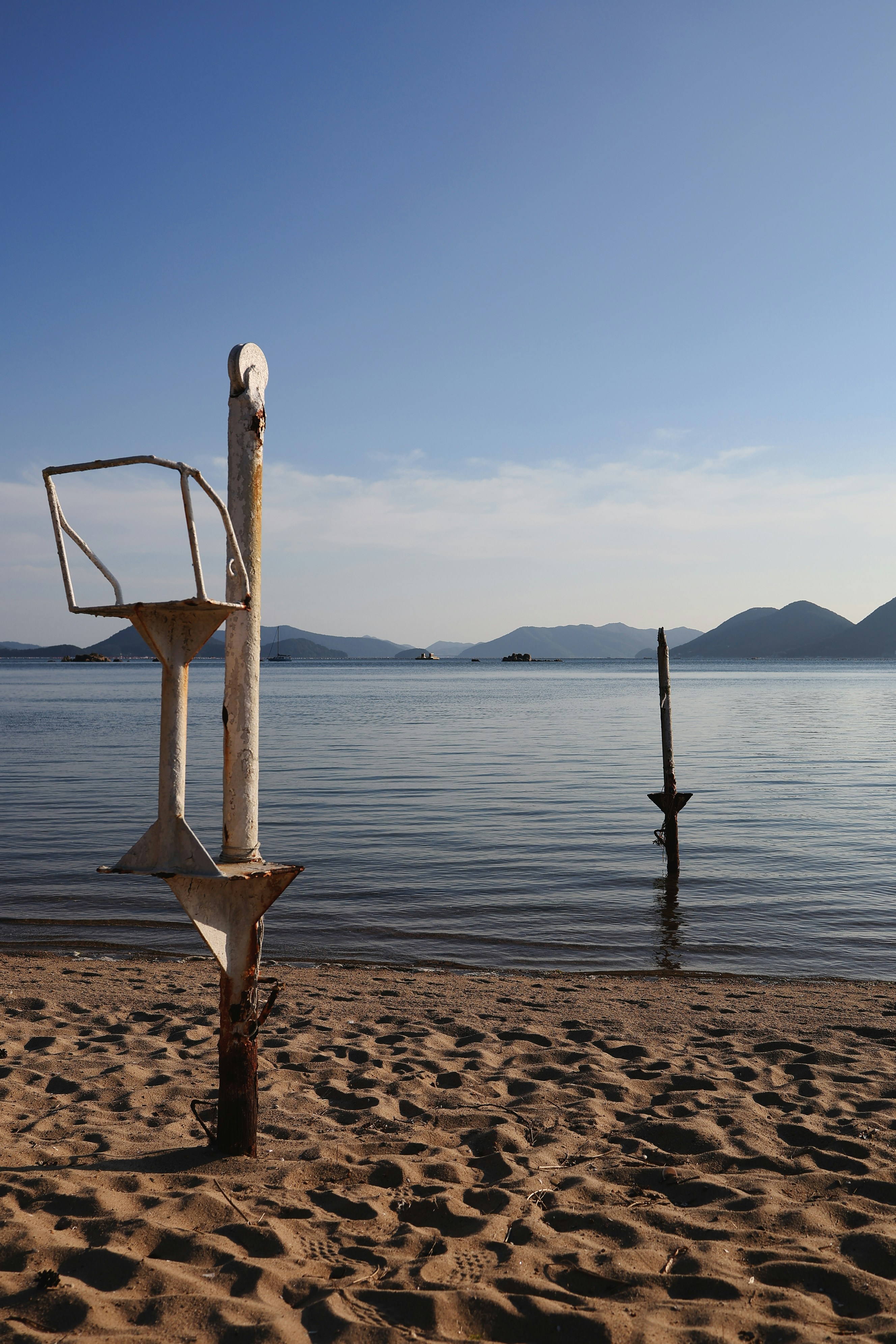 a sculpture on a beach next to a body of water