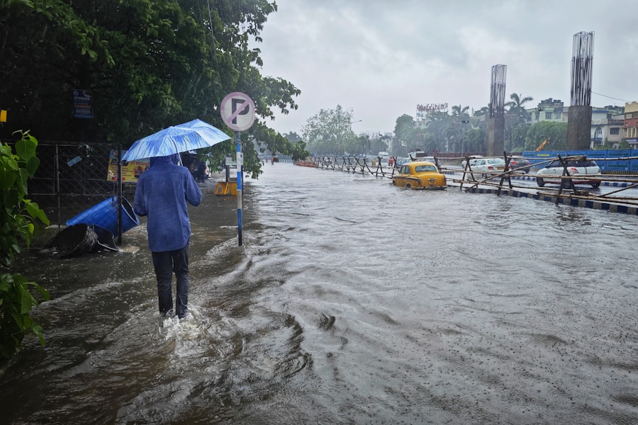 a person walking in a flooded street with an umbrella
