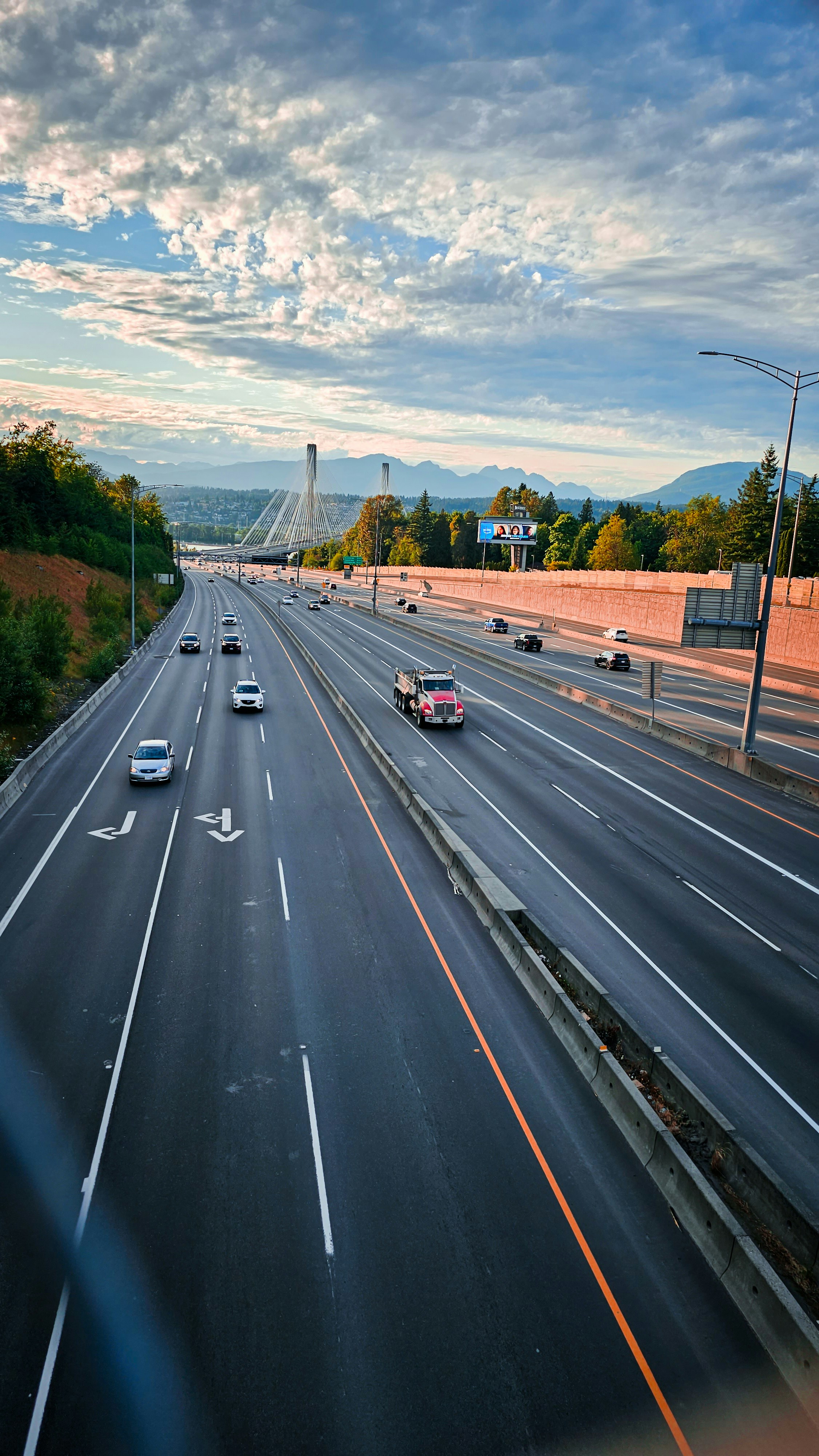 a highway with a bunch of cars driving down it