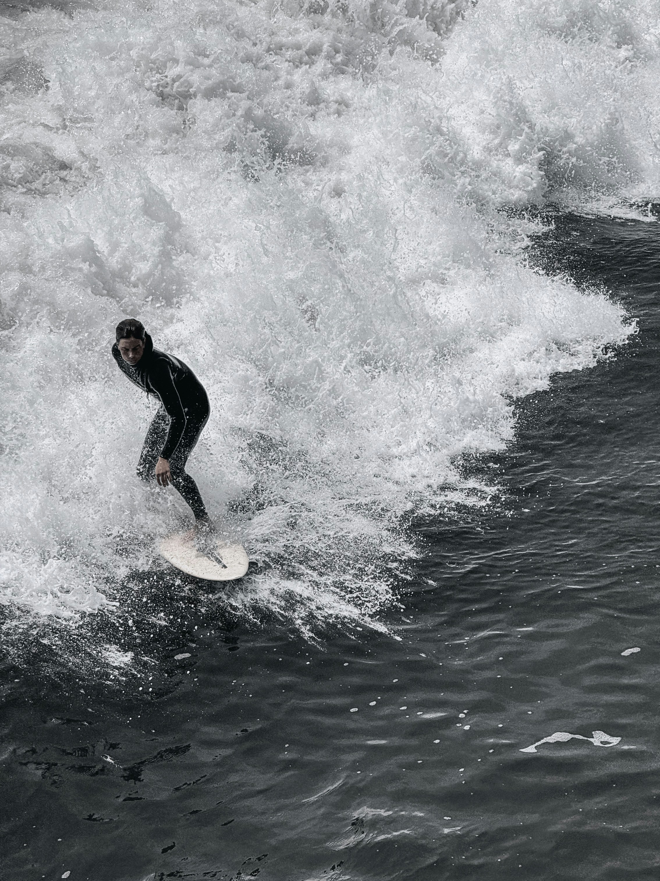 a man riding a wave on top of a surfboard