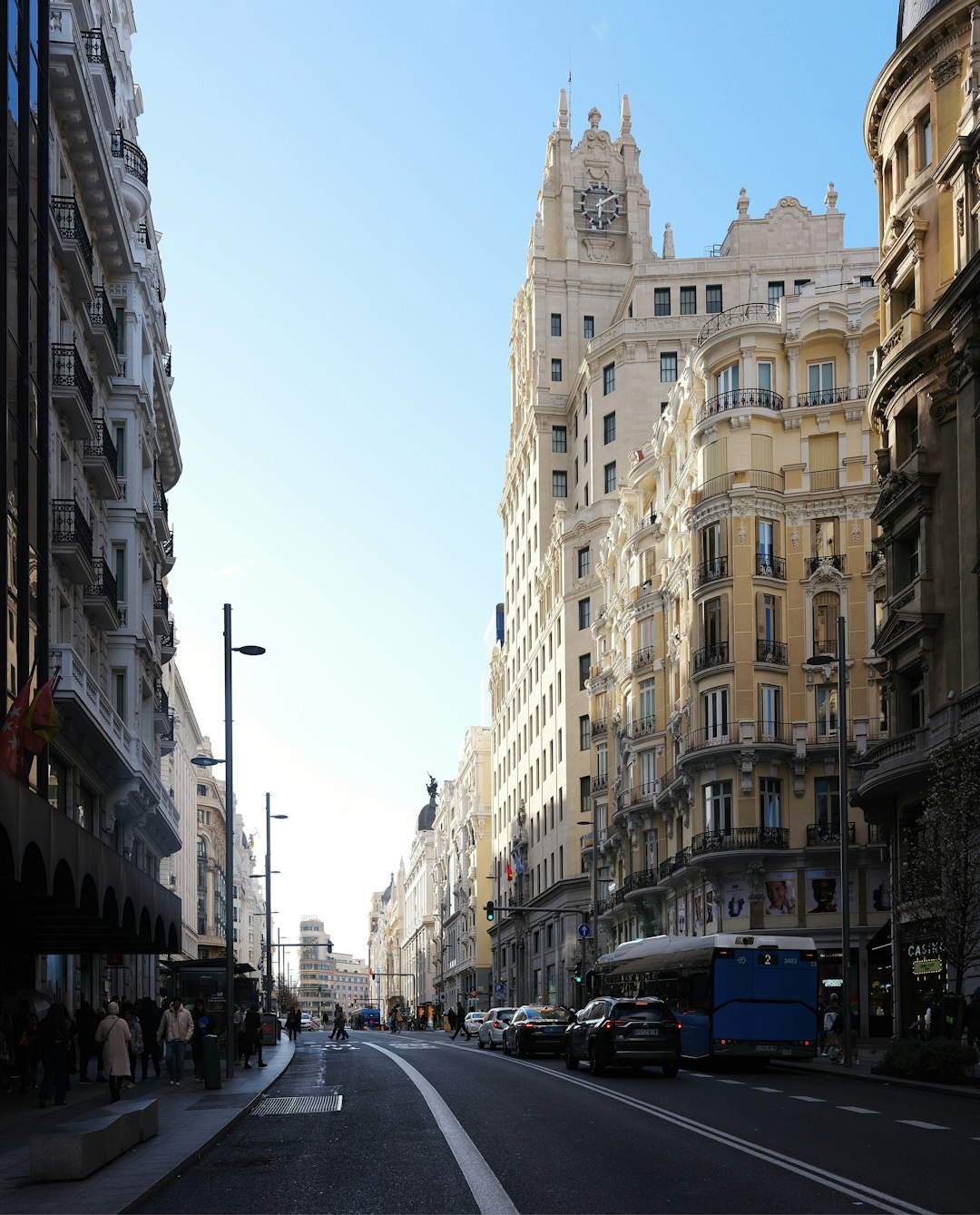 a city street lined with tall buildings and traffic