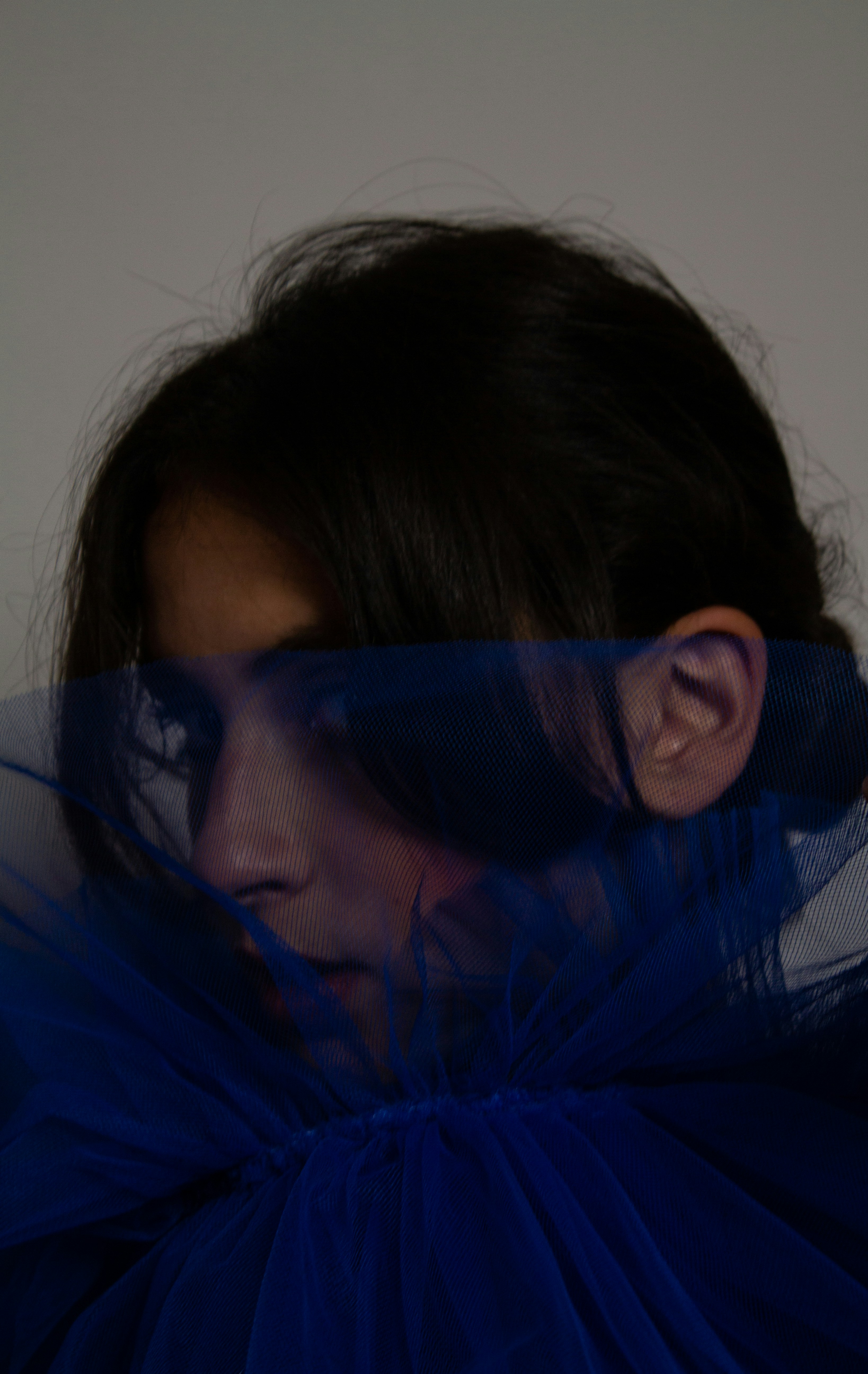 a woman with a veil over her face