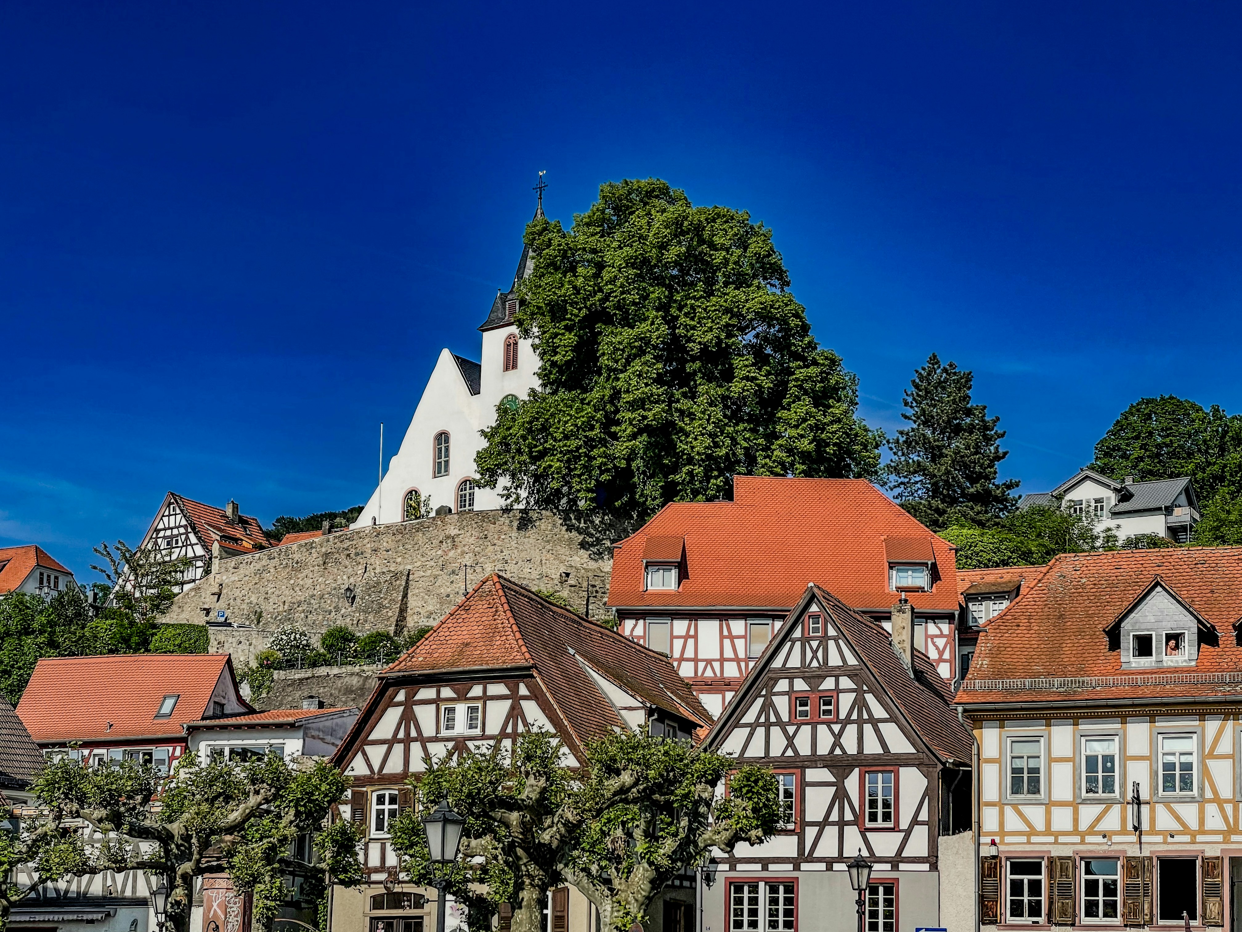 a row of buildings with a clock tower in the background