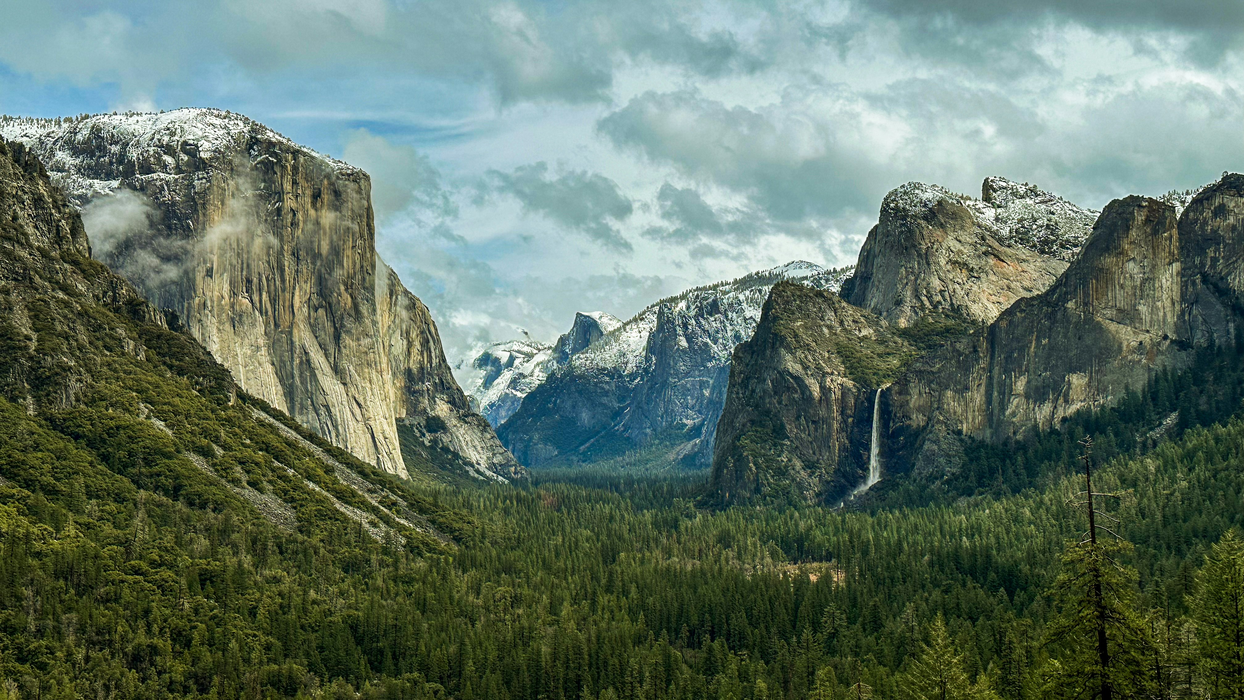 a view of a valley with mountains in the background