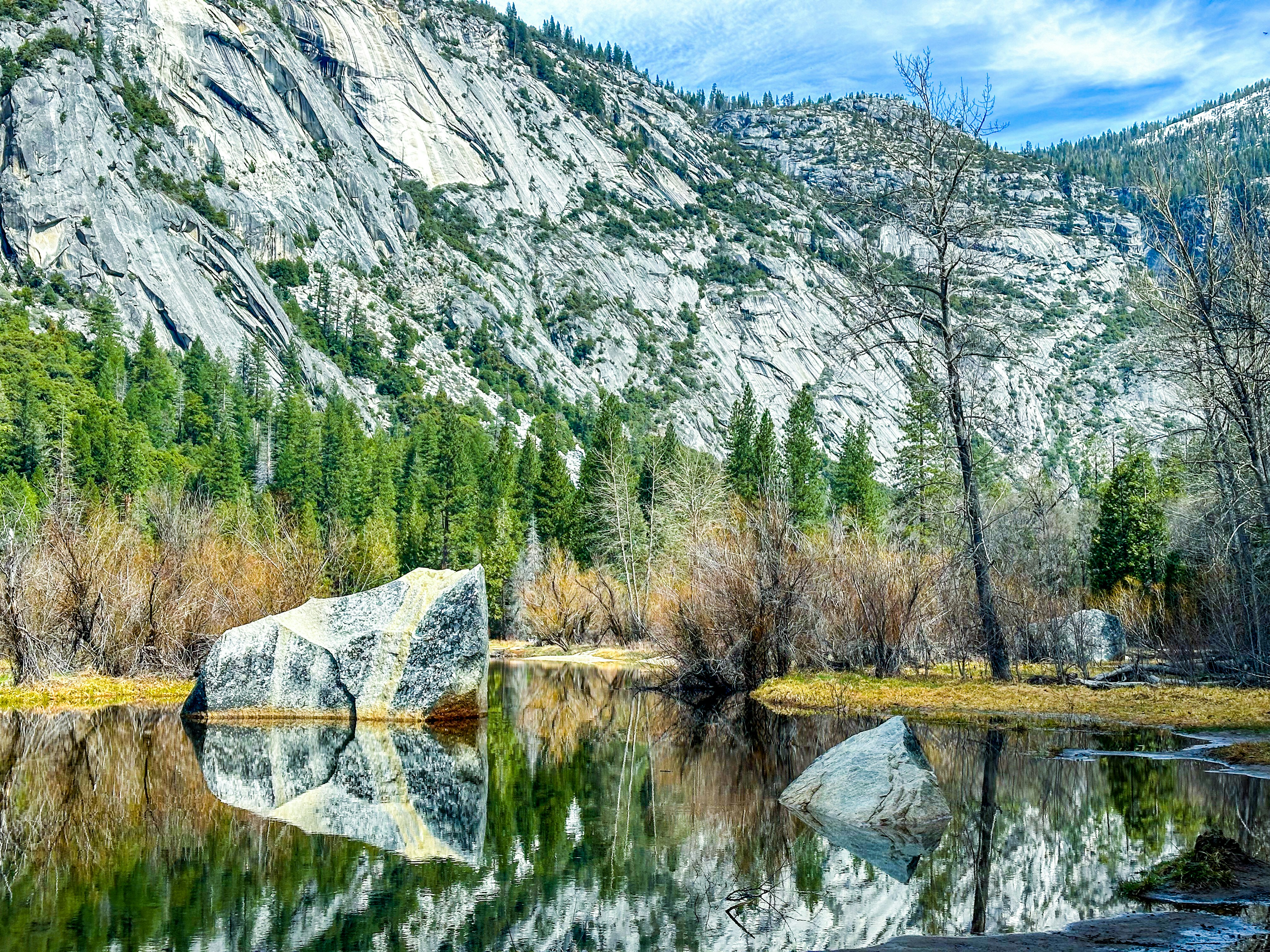 a large rock sitting in the middle of a lake
