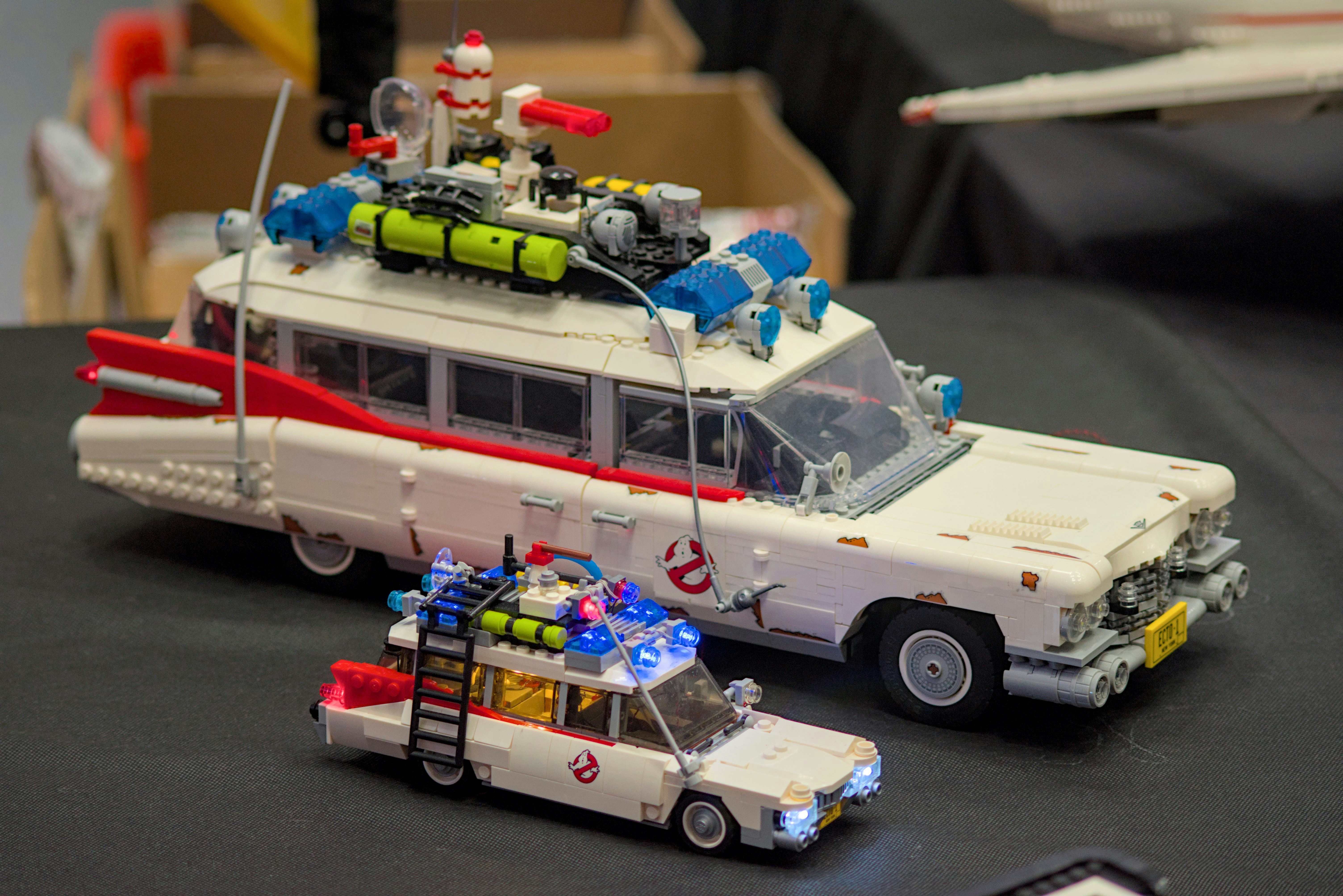 a toy bus and car are on a table