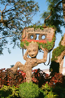 a statue of a groote holding up a radio