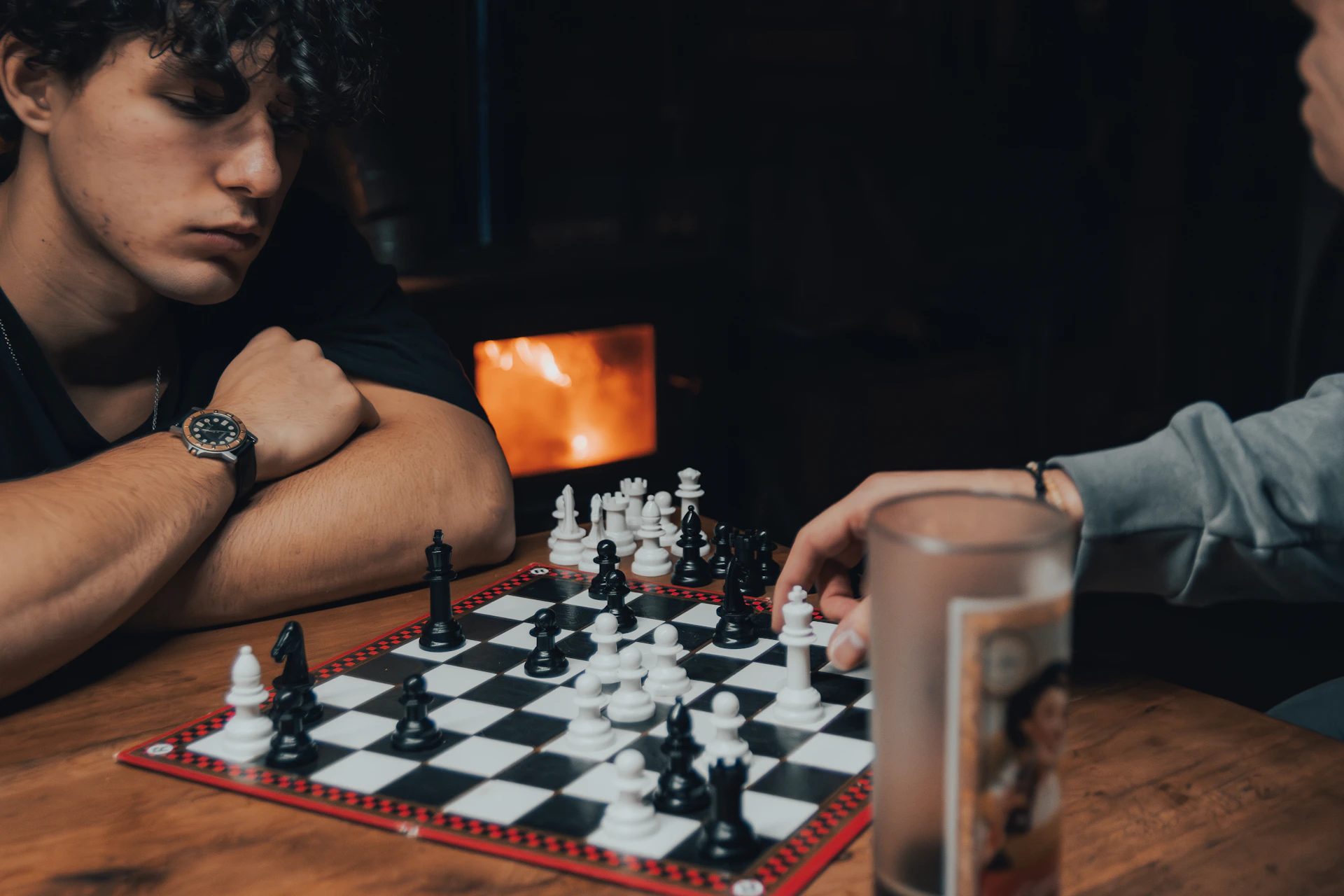 two men sitting at a table playing a game of chess