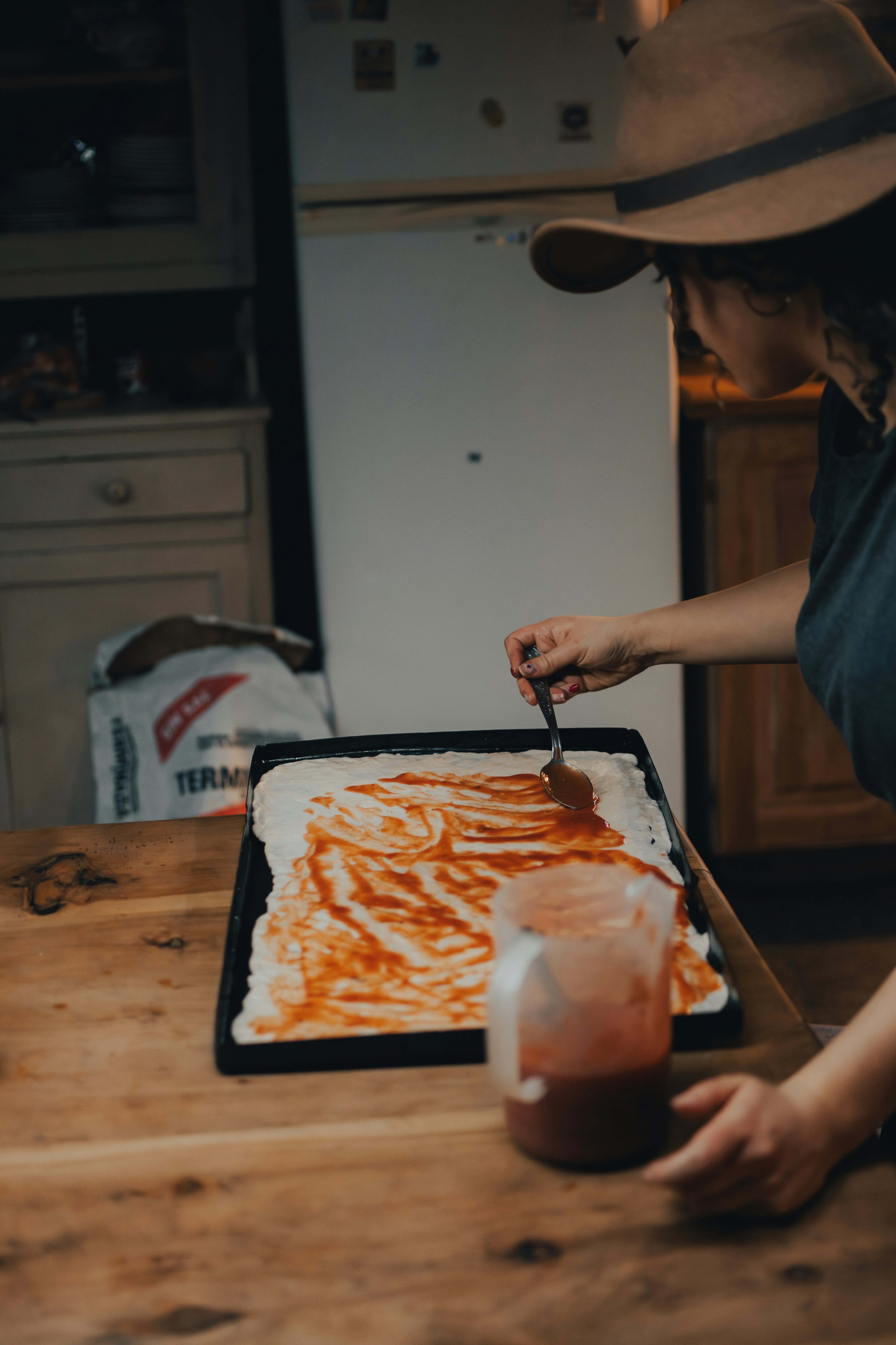 a woman cutting a cake with a knife