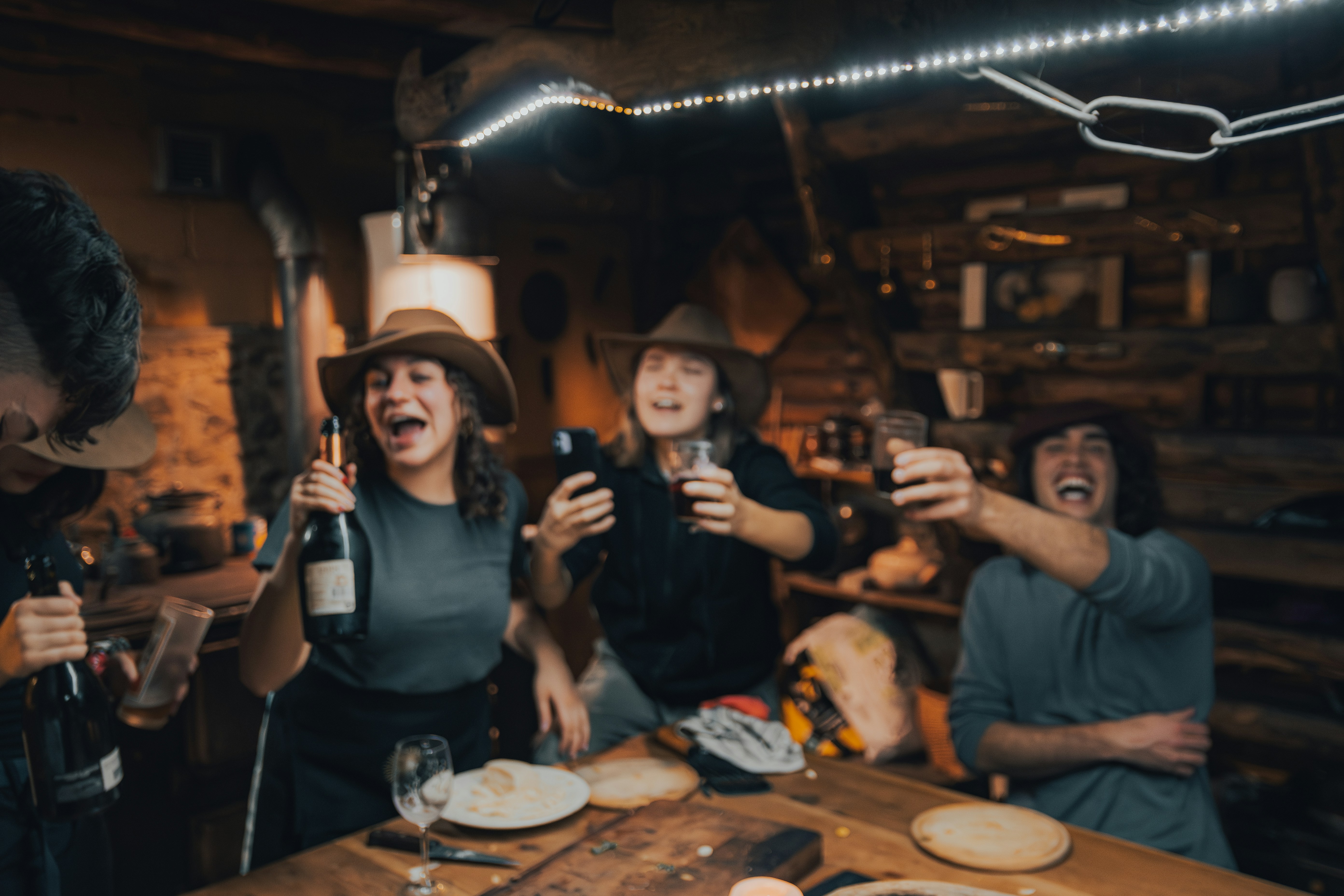 a group of people standing around a wooden table
