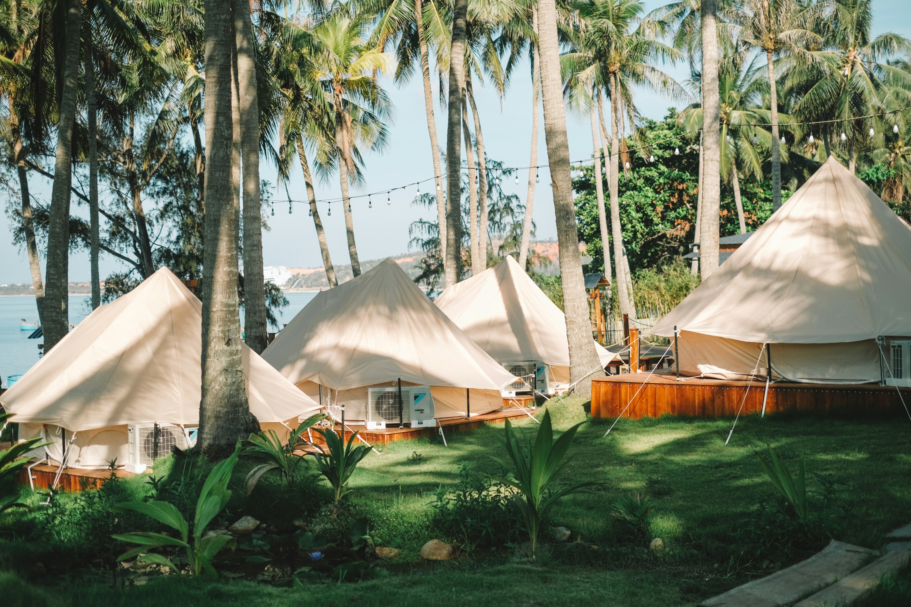 a group of tents sitting on top of a lush green field