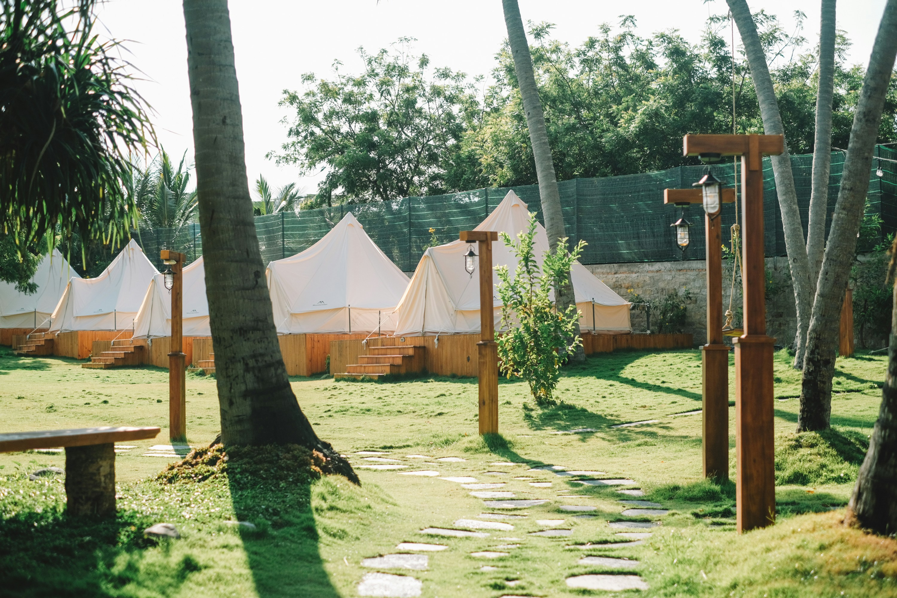 a group of tents sitting next to each other on a lush green field