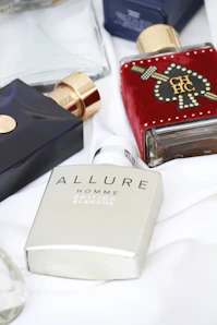 a table topped with bottles of different types of perfumes