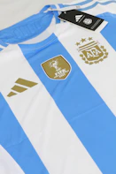 a blue and white striped shirt with a tag on it