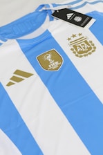 a blue and white striped shirt with a tag on it