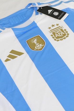 a blue and white striped shirt with a tag on it