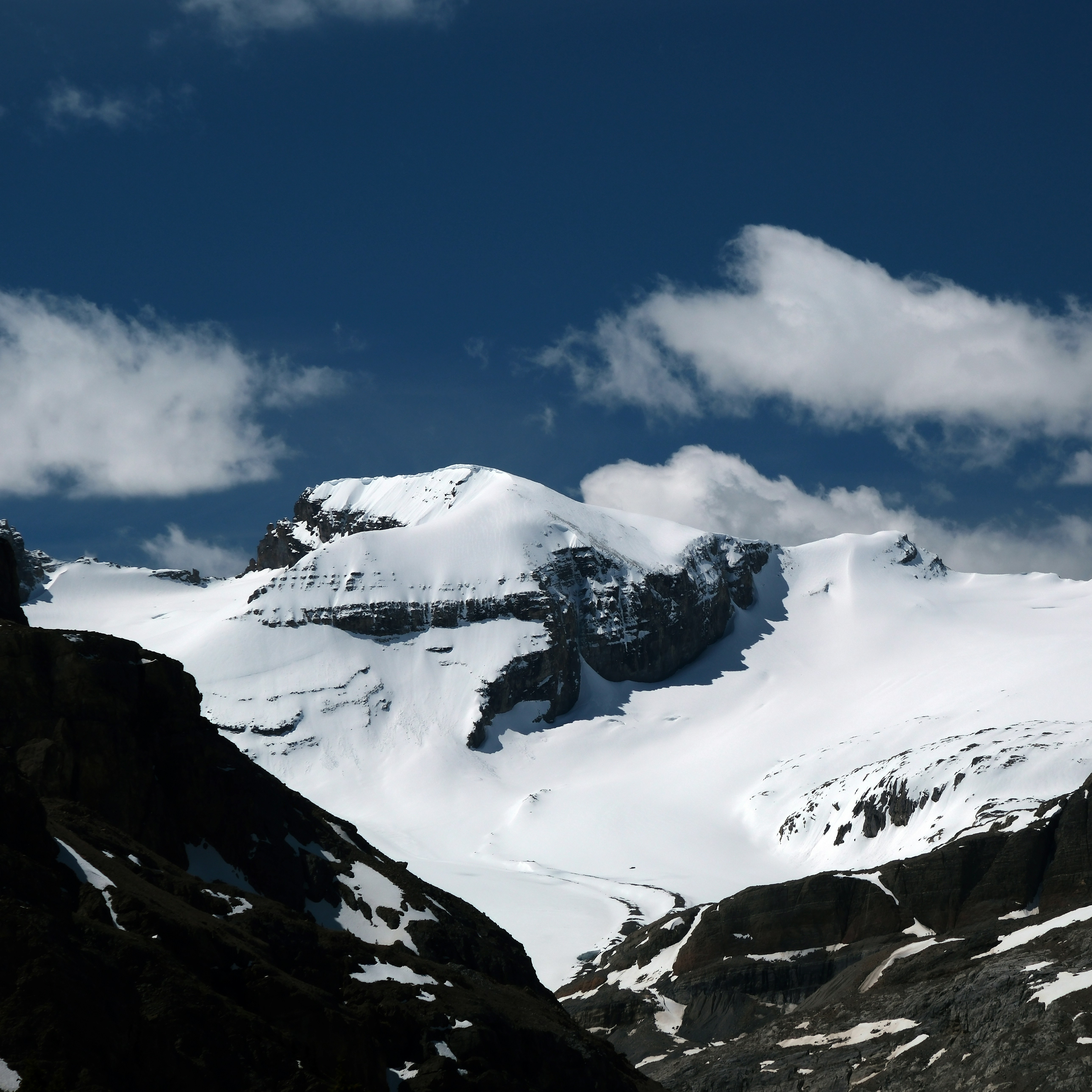 A mountain covered in snow under a blue sky photo – Free Mountain Image ...