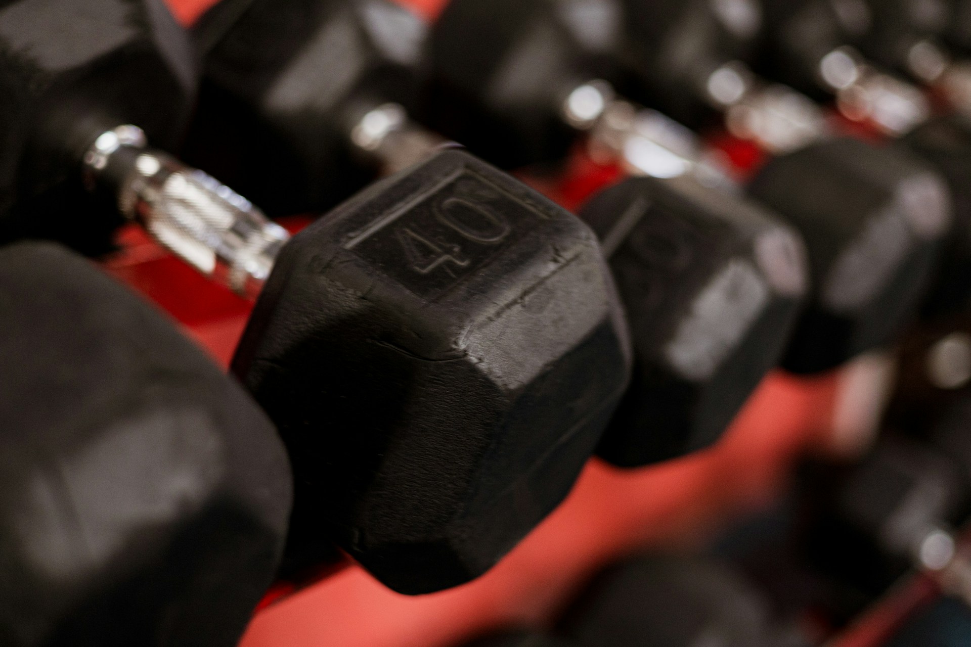 a row of black dumbs sitting next to each other