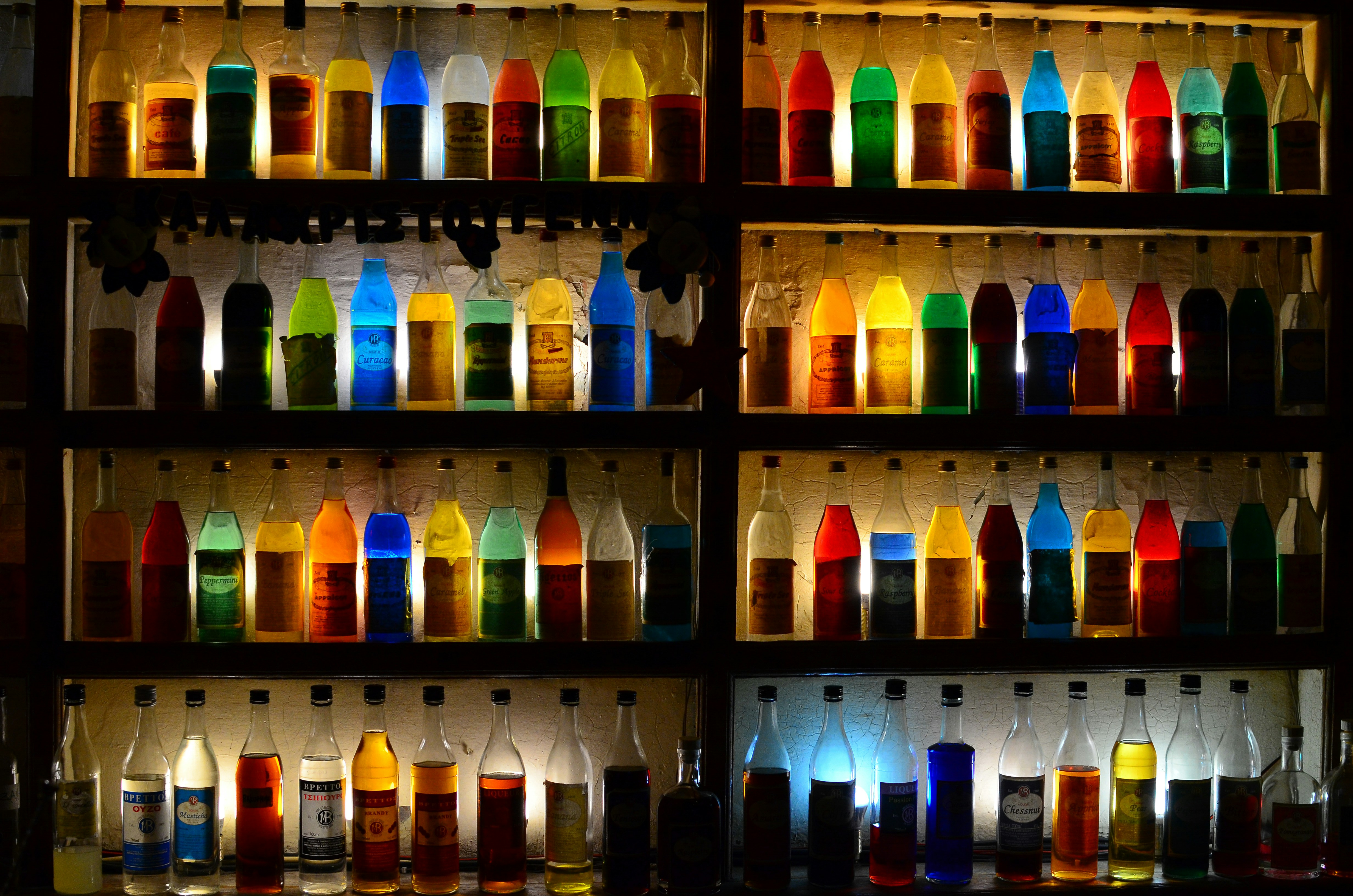 a wall full of bottles of different colors